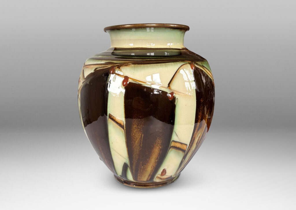 Gallery BAC globe form with angled shoulder and outstretched mouth with brass rim, decorated with a shiny glaze geometric design