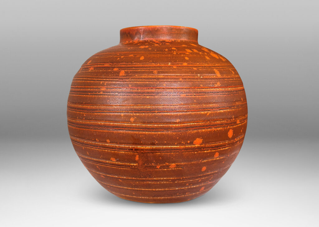 Gallery BAC globe form with carved pinstripe banding, glazed in matte orange-brown and orange