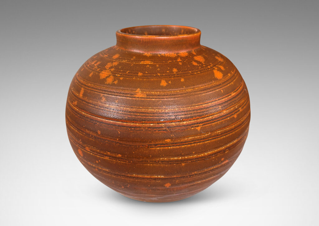 Gallery BAC globe form with carved pinstripe banding, glazed in matte orange-brown and orange