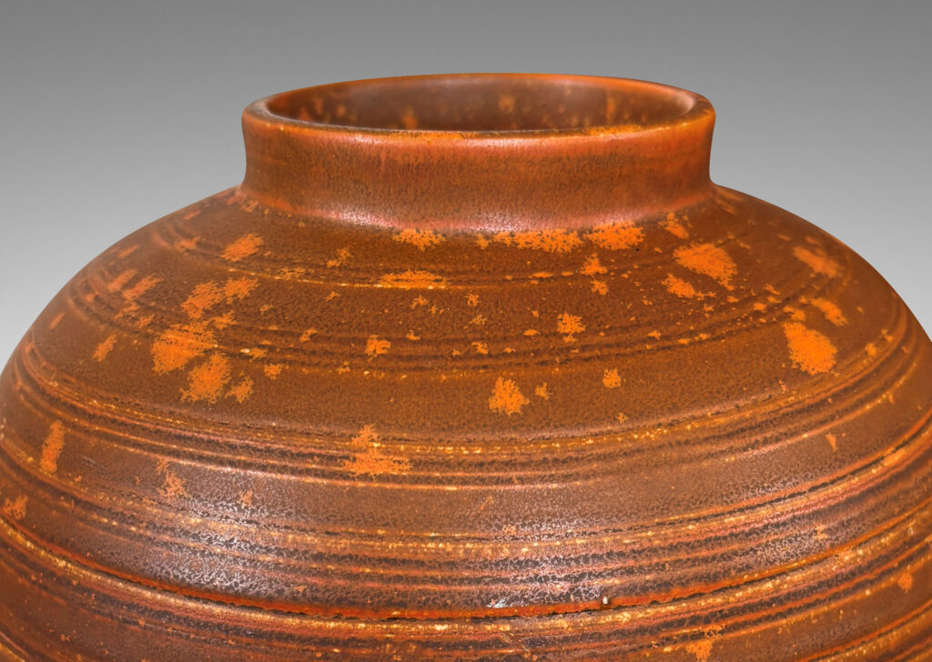 Gallery BAC globe form with carved pinstripe banding, glazed in matte orange-brown and orange