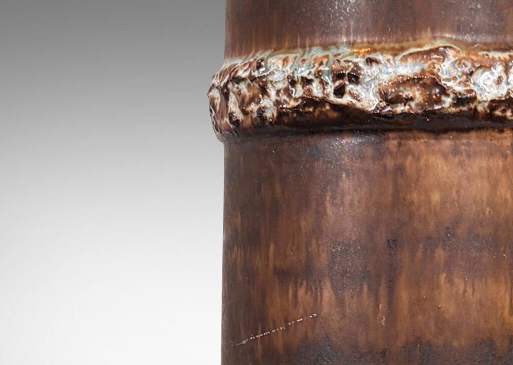 Gallery BAC cylindrical form with raised highly textured bands, glazed in matte flowing dark brown