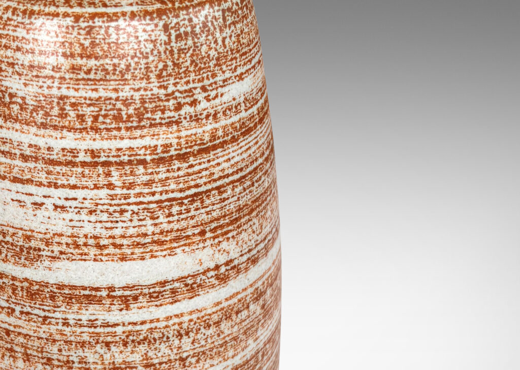 Gallery BAC organically modeled cylindrical form glazed in a warm brown striae over pale gray