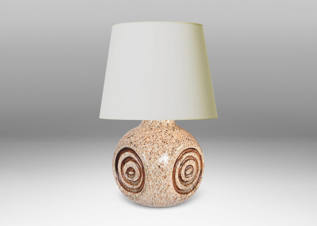 Gallery BAC squared globe form with carved concentric circle ornaments, glazed in stippled black and taupe over pale beige, with brown accents to motifs