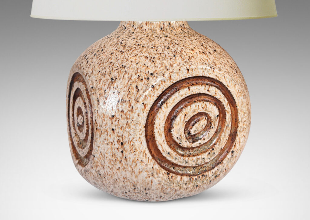 Gallery BAC squared globe form with carved concentric circle ornaments, glazed in stippled black and taupe over pale beige, with brown accents to motifs