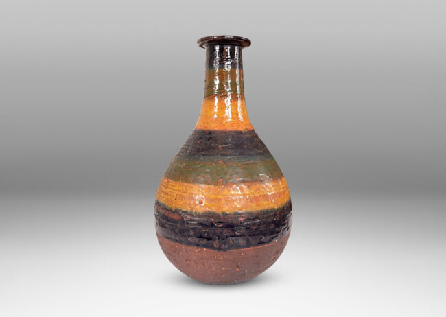 Gallery BAC bulbous form with sprouting neck and flange lip, partially glazed in shiny blue, green and yellow stripes over matte dark brown