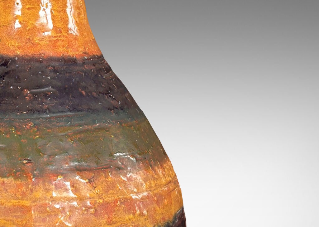 Gallery BAC bulbous form with sprouting neck and flange lip, partially glazed in shiny blue, green and yellow stripes over matte dark brown