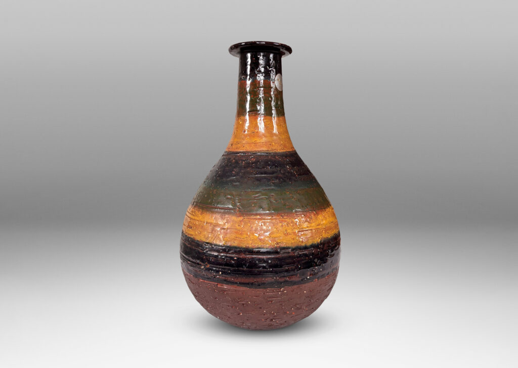 Gallery BAC bulbous form with sprouting neck and flange lip, partially glazed in shiny blue, green and yellow stripes over matte dark brown