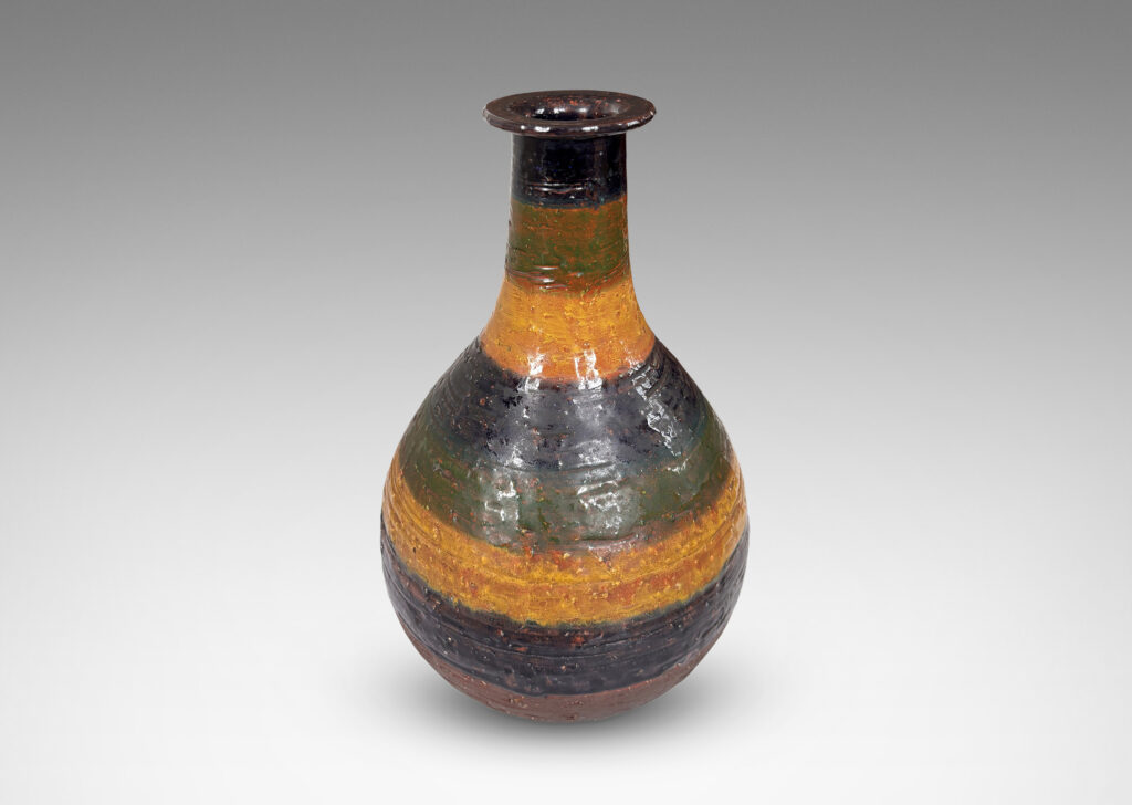 Gallery BAC bulbous form with sprouting neck and flange lip, partially glazed in shiny blue, green and yellow stripes over matte dark brown