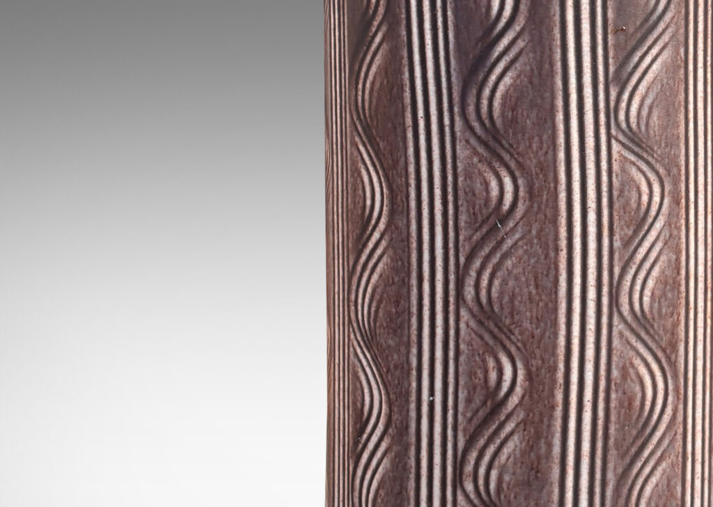 Gallery BAC cylindrical form with carved vertical stripes and waves, and outward curved lip, glazed in an eggshell finish mocha brown