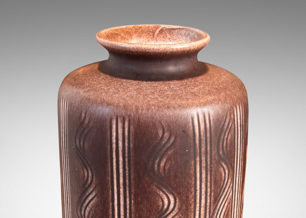Gallery BAC cylindrical form with carved vertical stripes and waves, and outward curved lip, glazed in an eggshell finish mocha brown
