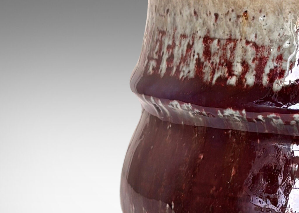 Gallery BAC organically modeled form glazed in oxblood burgundy, with dark and pale gray