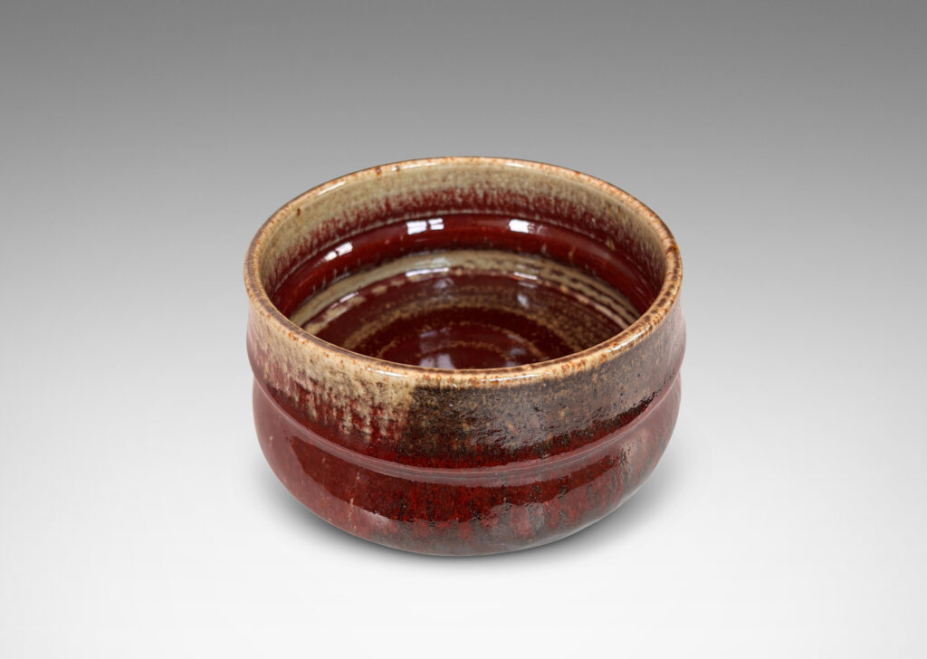 Gallery BAC organically modeled form glazed in oxblood burgundy, with dark and pale gray