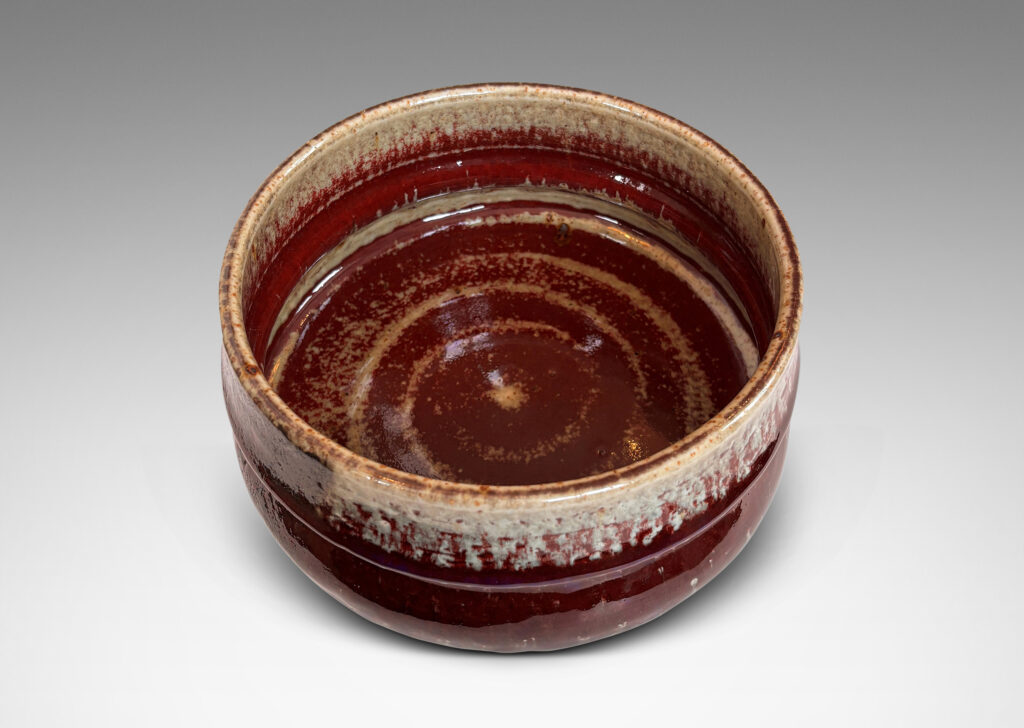 Gallery BAC organically modeled form glazed in oxblood burgundy, with dark and pale gray
