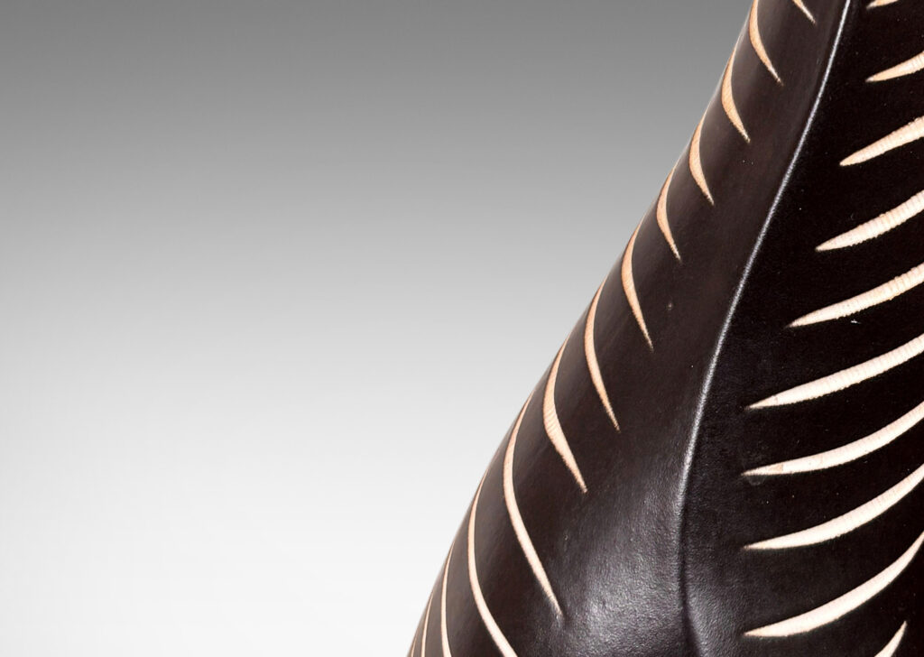 Gallery BAC whimsical animal-like form in black with carved stripes in white