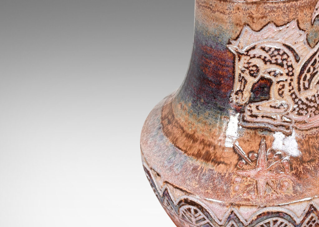 Gallery BAC carved bands of geometric foliate forms, a winged horse / Pegasus, and starbursts, glazed in puce-tan and purple-brown