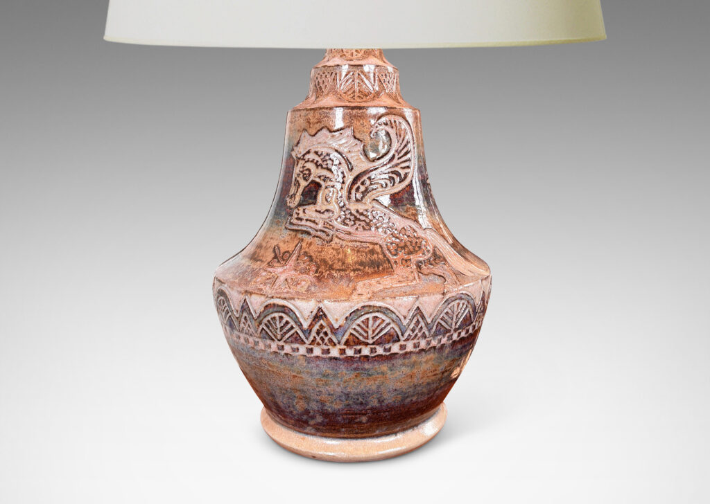 Gallery BAC carved bands of geometric foliate forms, a winged horse / Pegasus, and starbursts, glazed in puce-tan and purple-brown