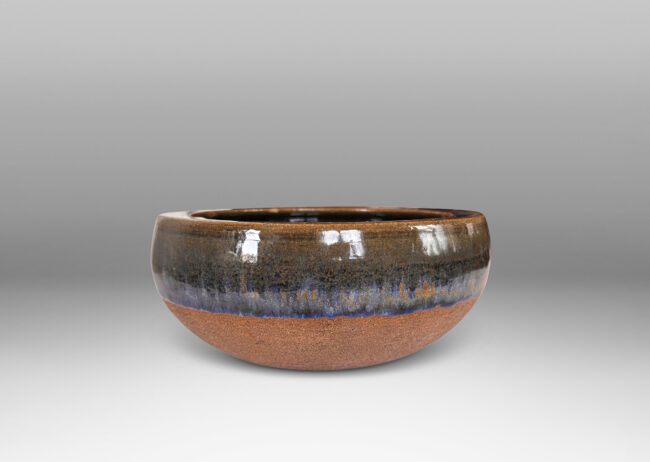 Gallery BAC round form with inward curving sides and carved spiral inside, partially glazed in glossy blue and green