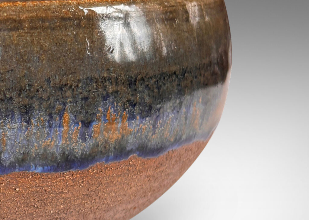 Gallery BAC round form with inward curving sides and carved spiral inside, partially glazed in glossy blue and green