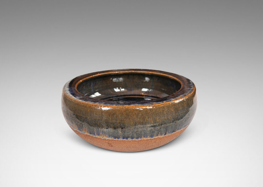 Gallery BAC round form with inward curving sides and carved spiral inside, partially glazed in glossy blue and green