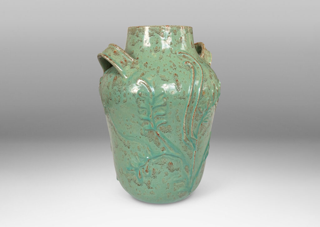 Gallery BAC gourd form with wide mouth, handles, and stylized floral reliefs, glazed in a mottled bright ceadon