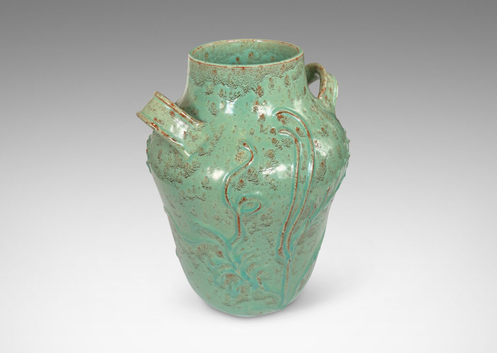 Gallery BAC gourd form with wide mouth, handles, and stylized floral reliefs, glazed in a mottled bright ceadon