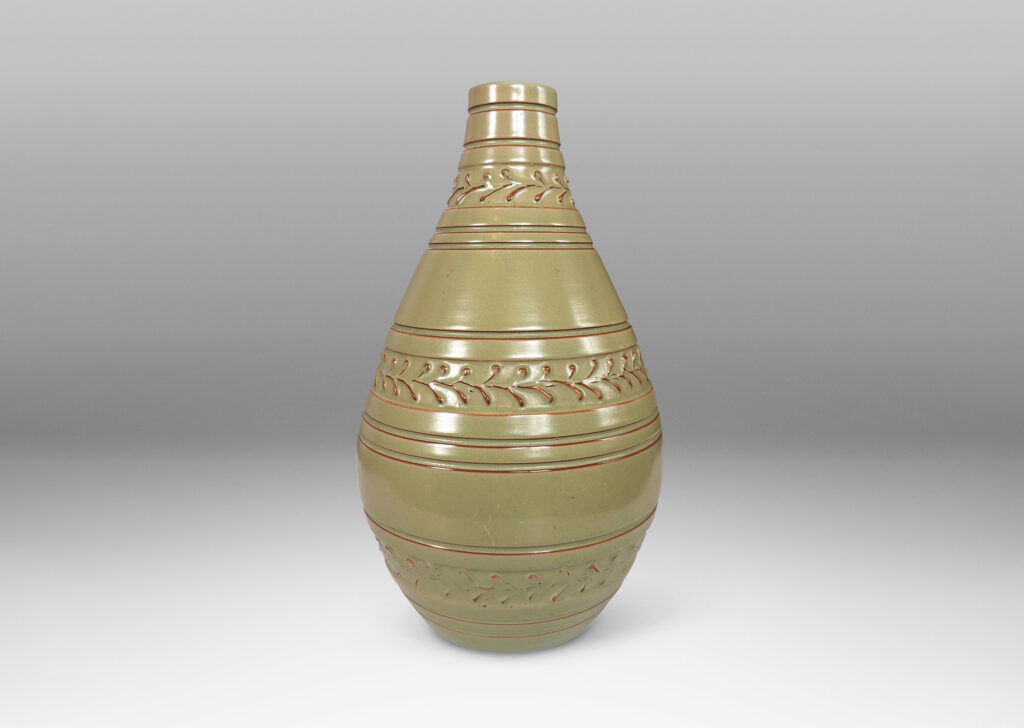 Gallery BAC tall swelling form with carved stripes and ornamental foliate bands, glazed in a pale celadon