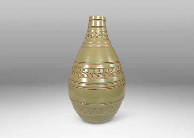 Gallery BAC tall swelling form with carved stripes and ornamental foliate bands, glazed in a pale celadon