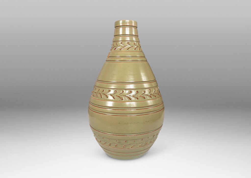 Gallery BAC tall swelling form with carved stripes and ornamental foliate bands, glazed in a pale celadon