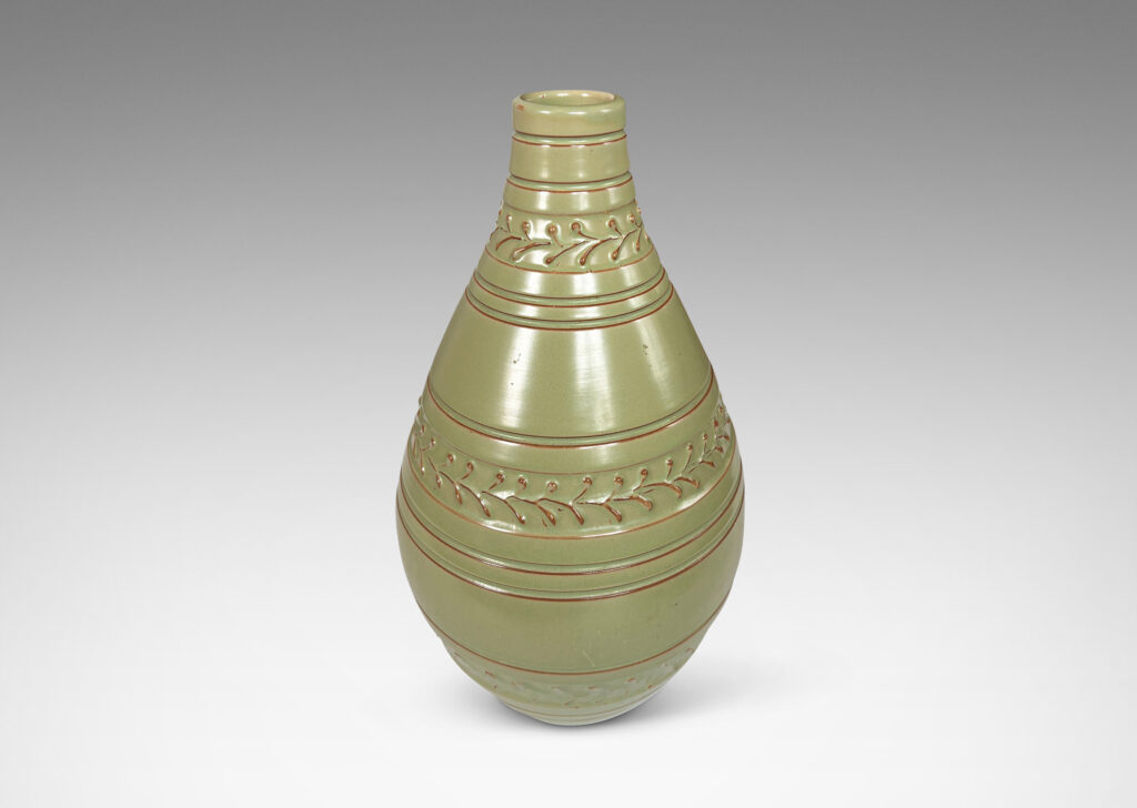 Gallery BAC tall swelling form with carved stripes and ornamental foliate bands, glazed in a pale celadon
