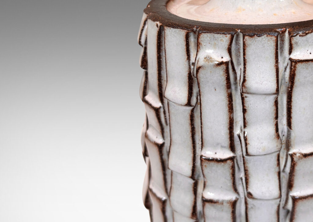 Gallery BAC cylindrical form with bark-like texture from applied rectangular strips, partially glazed in a shiny white, with exposed dark brown