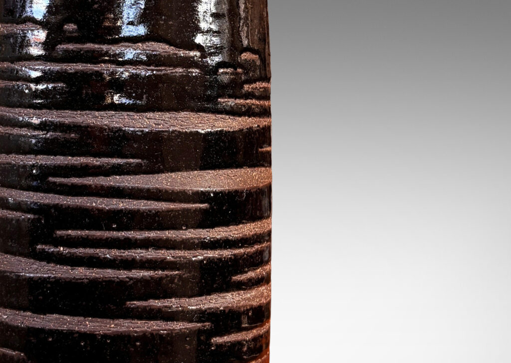 Gallery BAC cylindrical form in speckled brown ceramic partially overglazed with a striae effect thick glossy dark brown