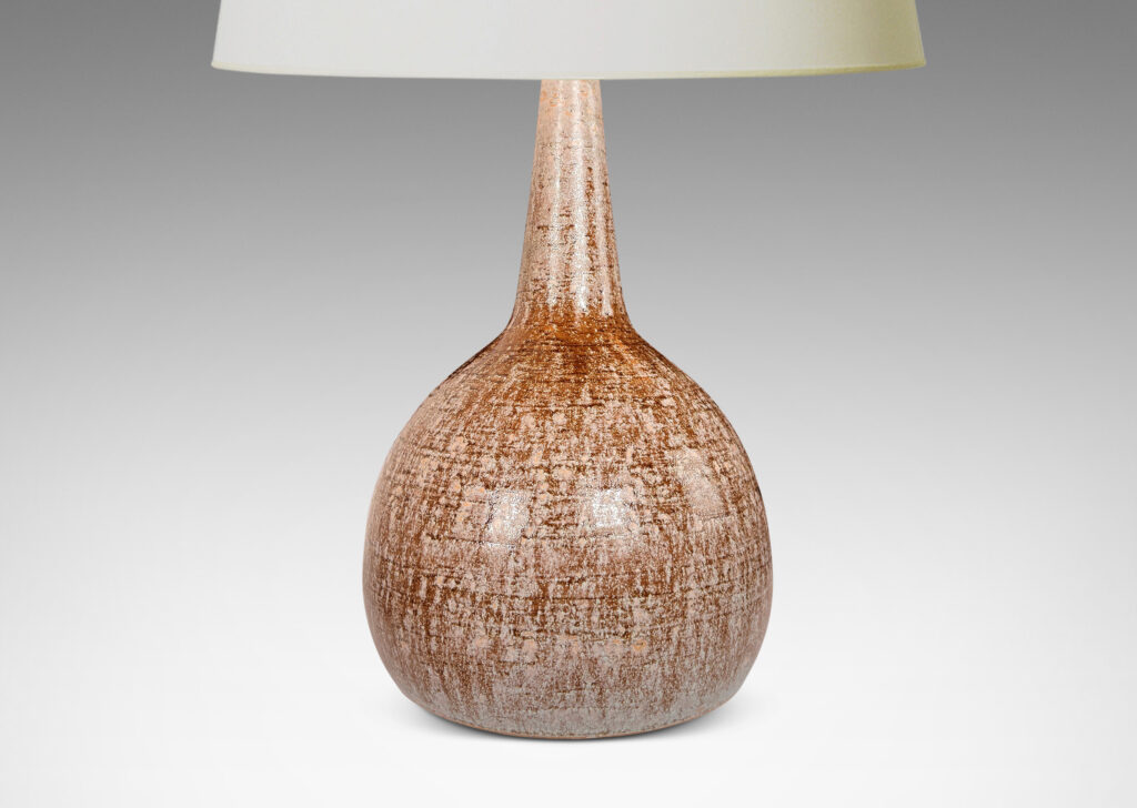 Gallery BAC bulbous form with tall, conical neck, glazed in pale beige over raw umber brown