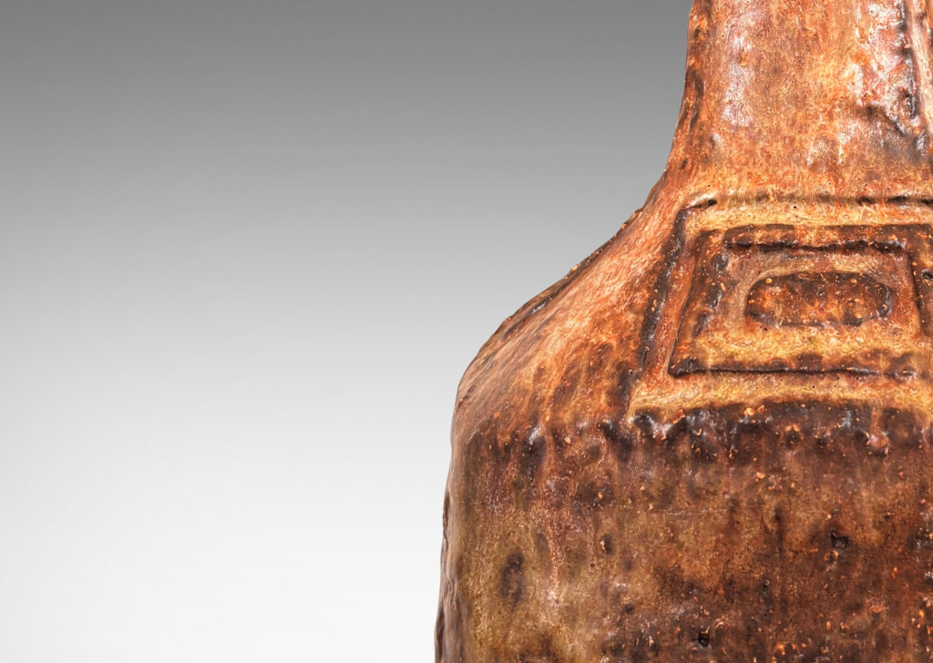 Gallery BAC low square form with attenuated neck and carved concentric rectangular motifs