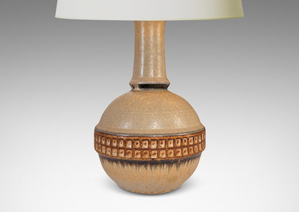 Gallery BAC globe form with notched neck and relief gridded band, glazed in pale beige with brown and gray accents
