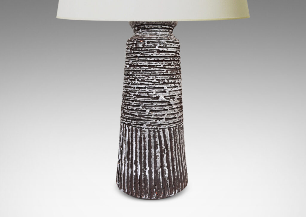 Gallery BAC upwardly tapered cylindrical form with carved horizontal and vertical ridges, glazed in matte brown with brushed gloss white accents