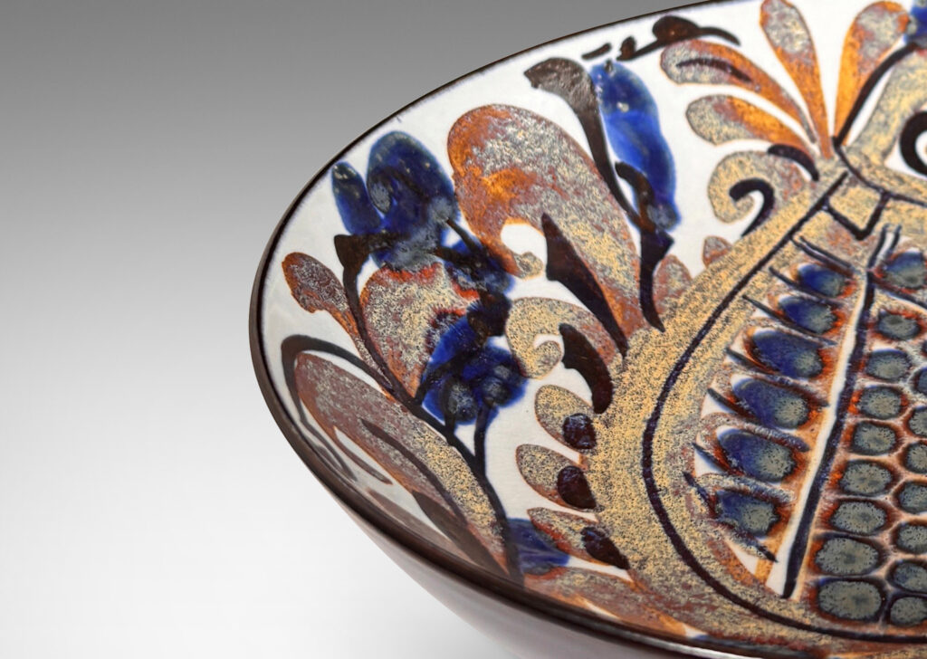 Gallery BAC simple arced sides, glazed inside with a rich paisley pattern in brown and blue luster with dark blue, over a pale gray-white, with dark blue exterior