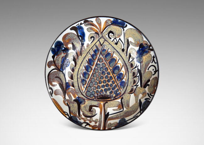 Gallery BAC simple arced sides, glazed inside with a rich paisley pattern in brown and blue luster with dark blue, over a pale gray-white, with dark blue exterior