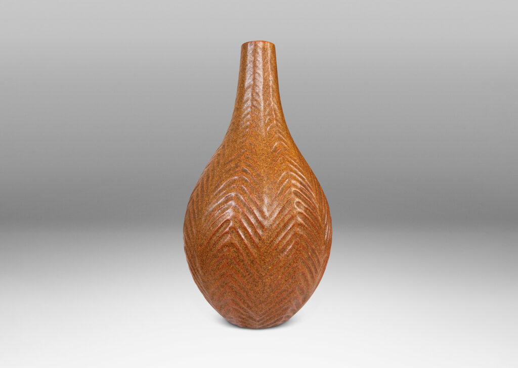 Gallery BAC drop form with slender sprouting neck and carved herringbone pattern, glazed in speckled sandy tan tones