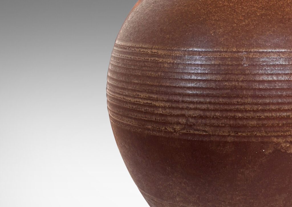 Gallery BAC globe forms with carved pinstripe banding, glazed in brown and yellow