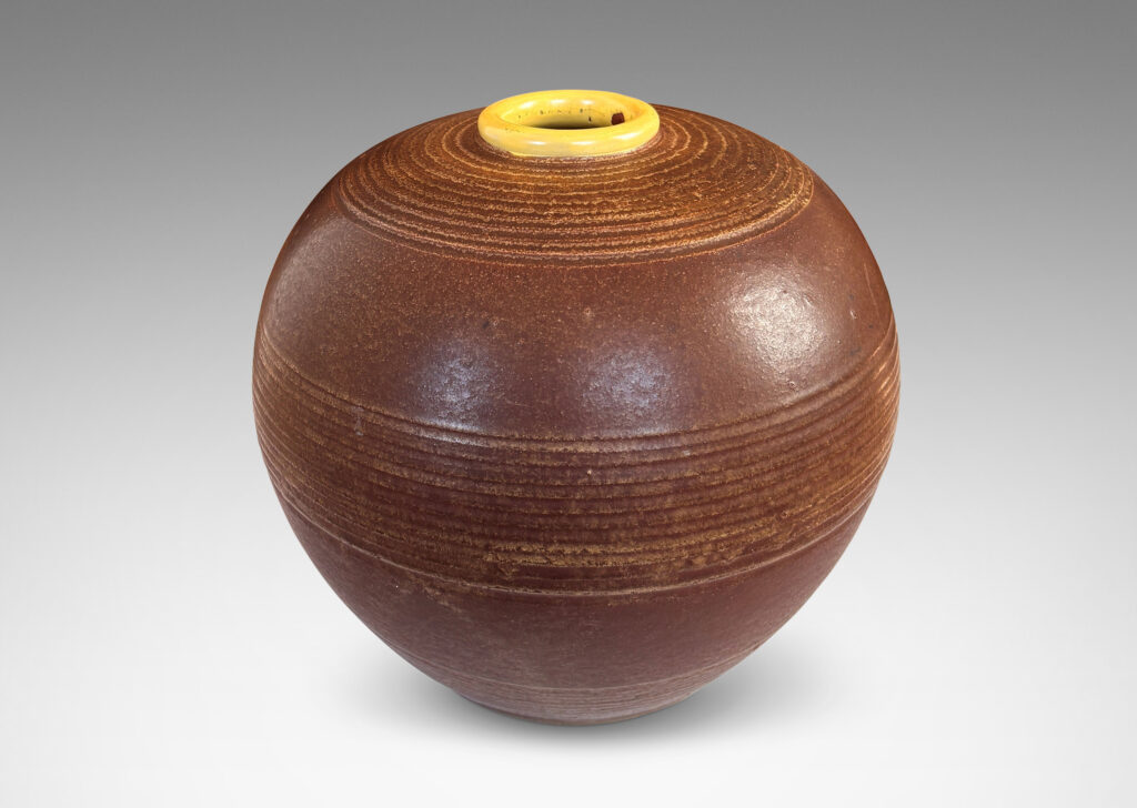 Gallery BAC globe forms with carved pinstripe banding, glazed in brown and yellow