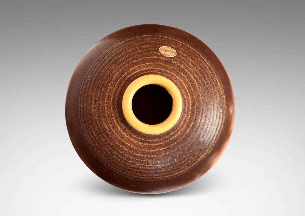 Gallery BAC globe forms with carved pinstripe banding, glazed in brown and yellow