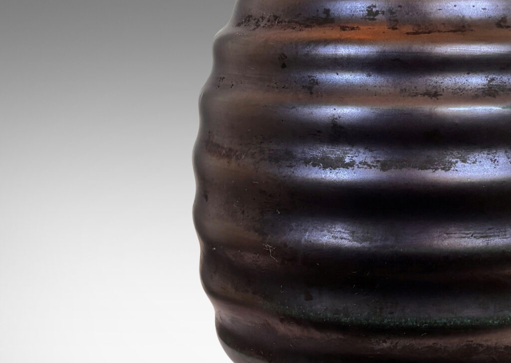 Gallery BAC ovoid form with sculptural horizontal ridging, glazed in a lustrous tonal teal-gunmetal