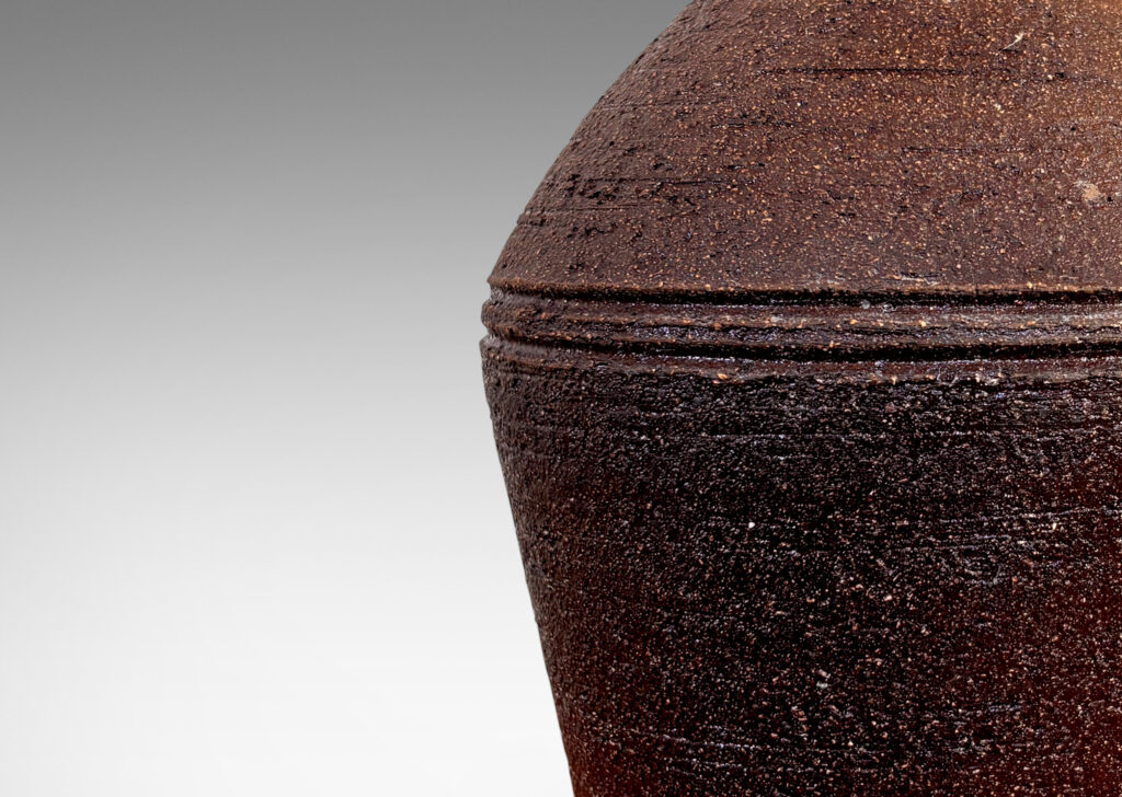 Gallery BAC angled form with banded edges and turning textures, with a matte dark brown finish
