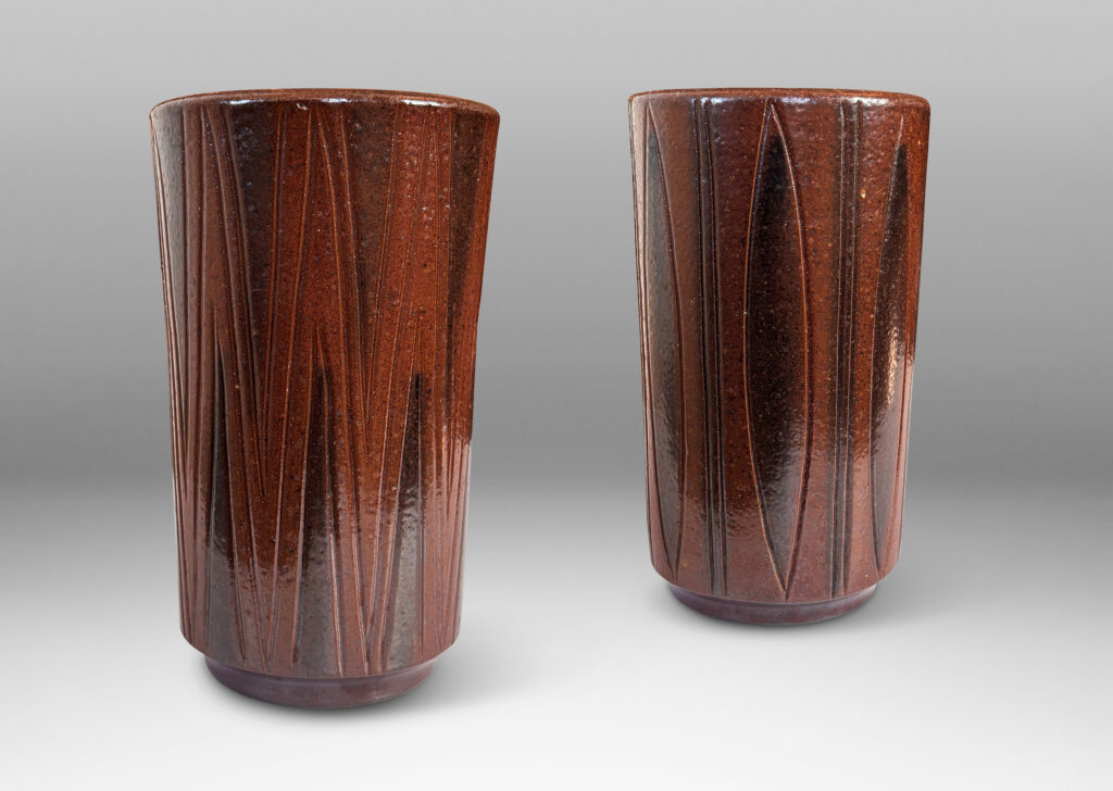 Gallery BAC cylindrical forms on floating reveals, with carved geometric patterns