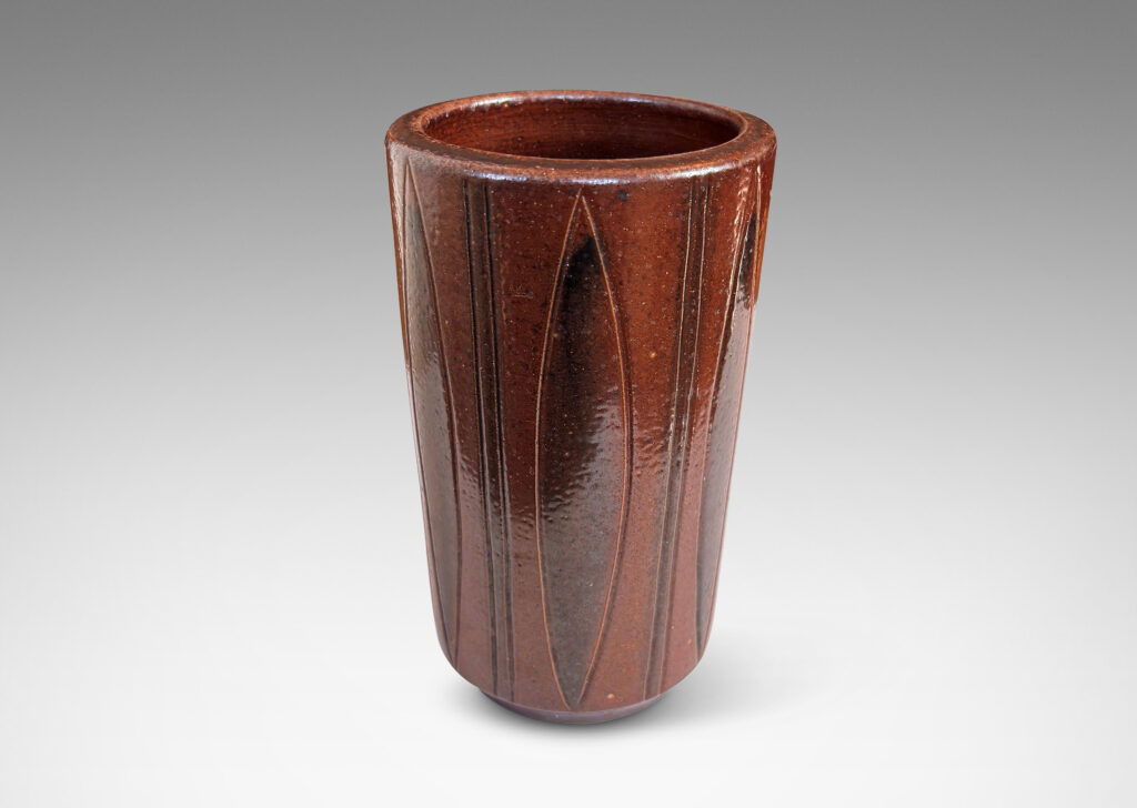 Gallery BAC cylindrical forms on floating reveals, with carved geometric patterns