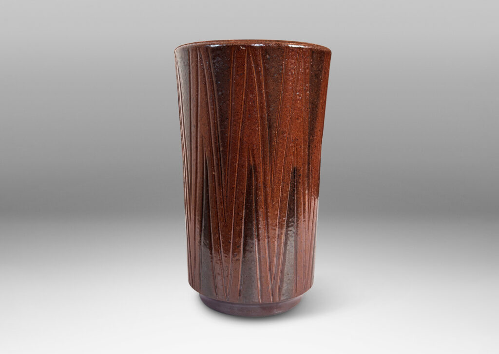 Gallery BAC cylindrical forms on floating reveals, with carved geometric patterns