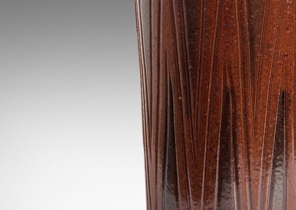 Gallery BAC cylindrical forms on floating reveals, with carved geometric patterns