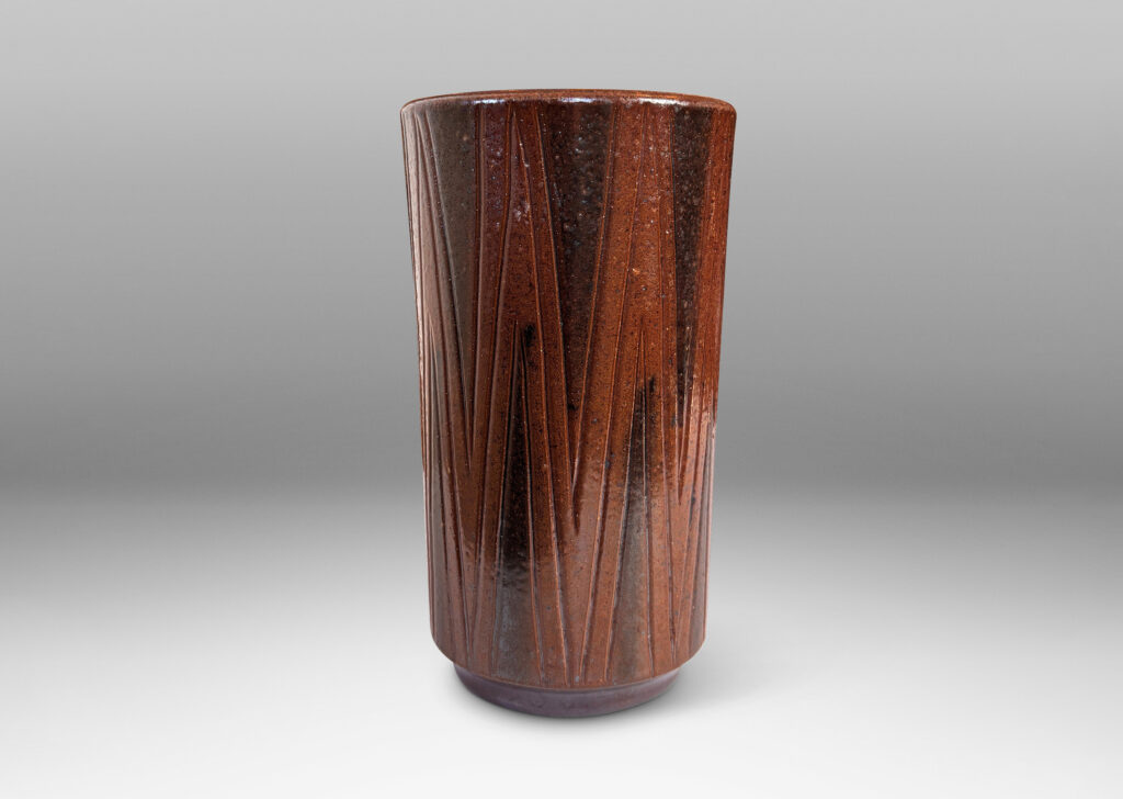 Gallery BAC cylindrical forms on floating reveals, with carved geometric patterns