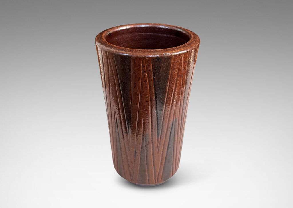 Gallery BAC cylindrical forms on floating reveals, with carved geometric patterns