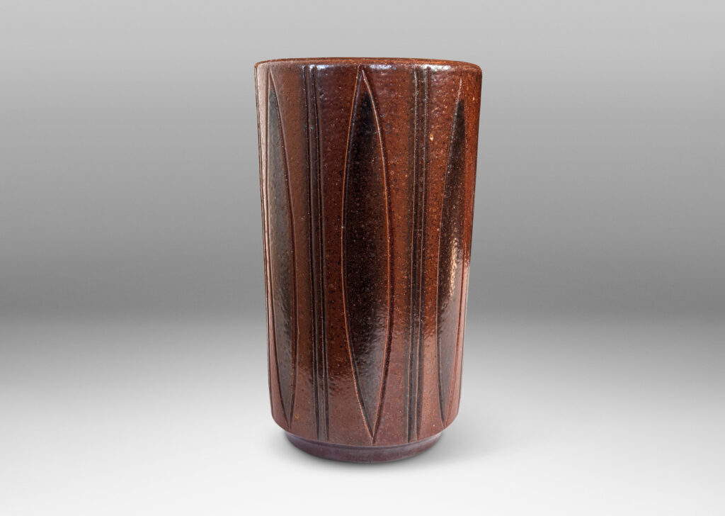 Gallery BAC cylindrical forms on floating reveals, with carved geometric patterns